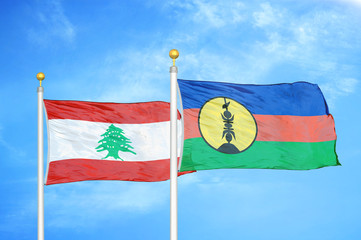 Lebanon and New Caledonia two flags on flagpoles and blue cloudy sky