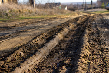 Traces of the tire tread of a car on a dirt road