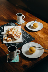 Table setting for breakfast - Plate, fork, cup and toast on the wooden table.