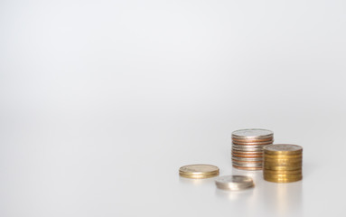 Four stacks of coins of different heights on a gray background: banner, text space, financial concept, Bank and loans