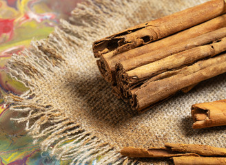 Ground cinnamon, cinnamon sticks, on old wooden background