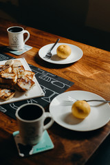 Table setting for breakfast - Plate, fork, cup and toast on the wooden table.