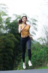 A young Asian woman is running