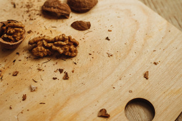Walnuts, broken shells. Nut kernels on a wooden Board. Close up. Background or texture.