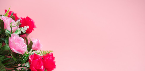 Fototapeta premium A bouquet of roses lies on a pink background: a banner, a place for text, a romantic concert for Valentine's day