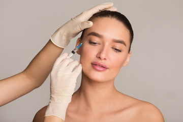 Woman with perfect skin receiving botox injection