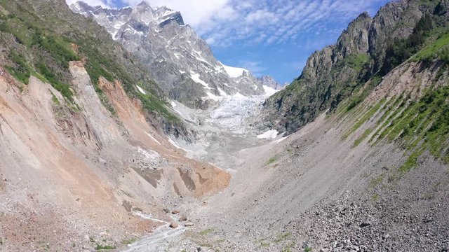 Caucasus Mountains on the border of Russia and Georgia. Chalaat Pass and Very beautiful view of the Chalaadi Glacier, Mount Ushba and Mestiachala river with background of clear blue sky.