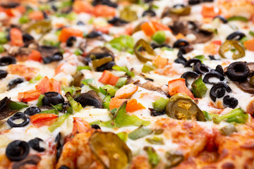 A closeup view of a veggie pizza pie.