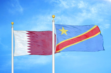 Qatar and Congo Democratic Republic two flags on flagpoles and blue cloudy sky