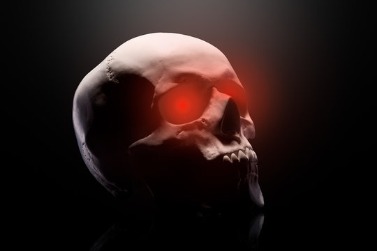 Model of the human skull with red eyes isolated on black background - Powered by Adobe