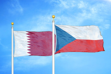Qatar and Czech Republic two flags on flagpoles and blue cloudy sky