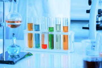 A tube of biological sample contaminated by coronavirus with label COVID-19 for analysis and sampling of COVID-19 infectious disease, coronavirus covid-19 vaccine research by chemistry and scientist.