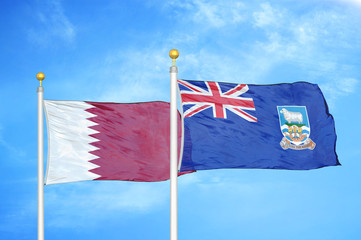 Qatar and Falkland Islands two flags on flagpoles and blue cloudy sky