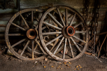 Fototapeta na wymiar old wooden wagon wheels in shed