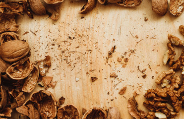 Walnuts, broken shells. Nut kernels on a wooden Board. Close up. Background or texture.