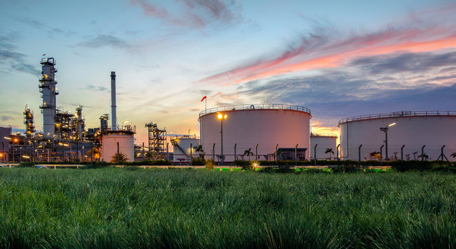 Oil And Gas Industry, Oil Refinery Industry, Refinery Form Factories, Oil Storage Tanks And Steel Pipes With Sunset Background