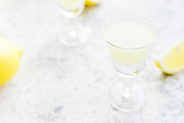 Italian traditional liqueur limoncello with lemon