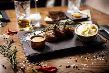 Pork tenderloin served on a board in restaurant