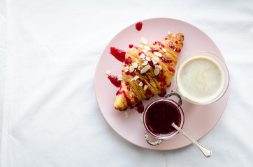 Cup of coffee, croissant and jam