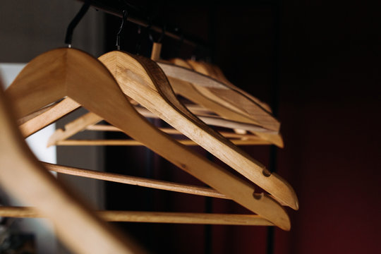 Rack with wooden clothes hangers. Warm colors. Abstraction. Clothes shop, hotel, waiting concept.