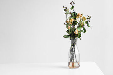 Bouquet of wilted flowers on a white background