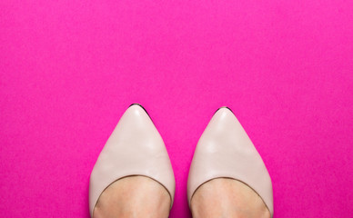 Pair of female shoes with toes on pink background. free copy space. Overhead shot of elegant shoes. Top view. Concept of fashion.