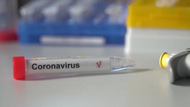 coronavirus test. Test tube lying on inspiratory protective respiratory mask. COVID-19 test or SARS-CoV-2 test. Stop spreading