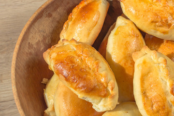 Baked cakes. Yeast baking. Pies with meat, cabbage and mushrooms. Homemade food. Slavic cuisine. Delicious pastries. Ruddy snack. Flour product. Bake in the oven. Junk food.