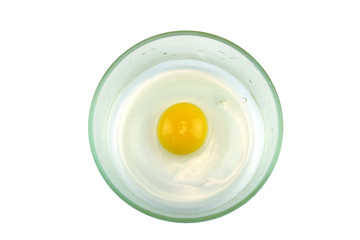 top view of chicken egg yolk in glass bowl