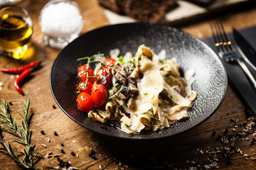 Black Angus Pasta served in a black bowl in restaurant