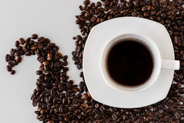 White cup with coffee and saucer, with scattered coffee beans on a white background. Great idea for a cafe, restaurant or cafeteria menu or as a sign
