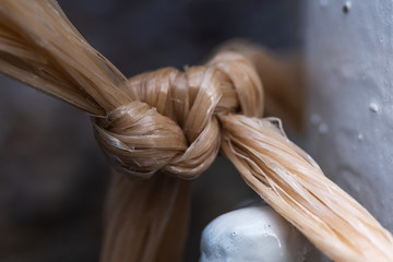 Close up on a plastic bag knot. Plastic knot. Knot trash bag. Close up plastic and details