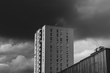 Skyscraper with a stormy background. Tower building during storm. Construction with heavy clouds. Black and white version, France - Nantes, 2020