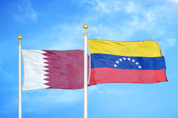 Qatar and Venezuela two flags on flagpoles and blue cloudy sky