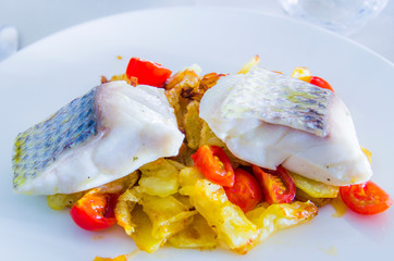 baked sea bass with fried vegetables and roasted cherry tomatoes