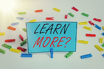 Word writing text Learn More question. Business photo showcasing gain knowledge or skill studying practicing Colored clothespin papers empty reminder white floor background office
