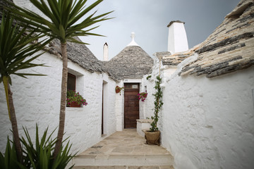 The beautiful white yards with a special houses of Alberobello in the southern part of Italy near...