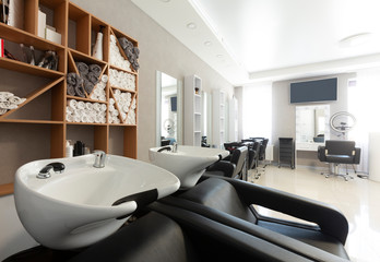 Black head-wash armchairs at modern beauty salon