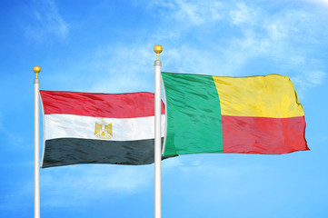 Egypt and Benin  two flags on flagpoles and blue cloudy sky