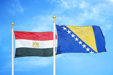 Egypt and Bosnia and Herzegovina  two flags on flagpoles and blue cloudy sky