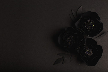 black background with a beautiful gold glittering flowers made of paper