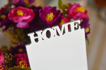 Text home, close-up. The lettering home on the floral purple background.