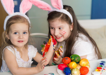  Girls paint easter eggs