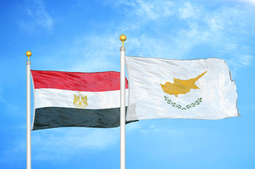 Egypt and Cyprus two flags on flagpoles and blue cloudy sky