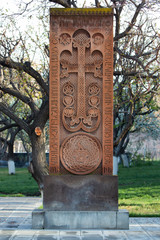 Fototapeta na wymiar Medieval khachkar covered with carved ornaments and figures. Ejmiatsin, Armenia