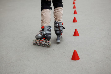 inline skates moving through a skatepark. freestyle slalom