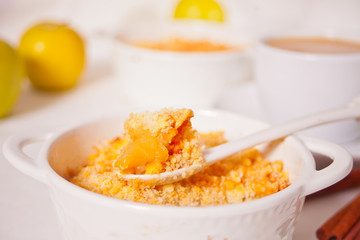 Tasty homemade apple crumble dessert on the white background.