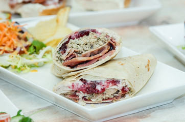 A selection of various sandwiches and fillings, garnished with crisps and salad.