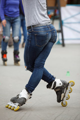 inline skates moving through a skatepark. freestyle slalom