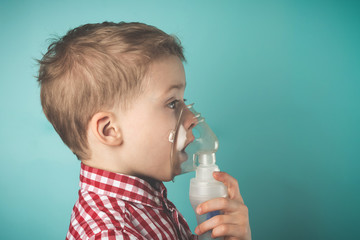 Inhalation child infant under five year. Boy making inhalation with nebulizer at home